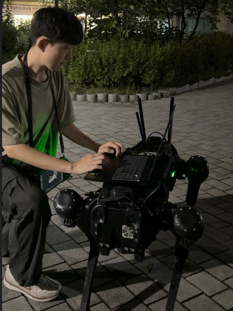 Jintae Park working on a quadruped robot at night